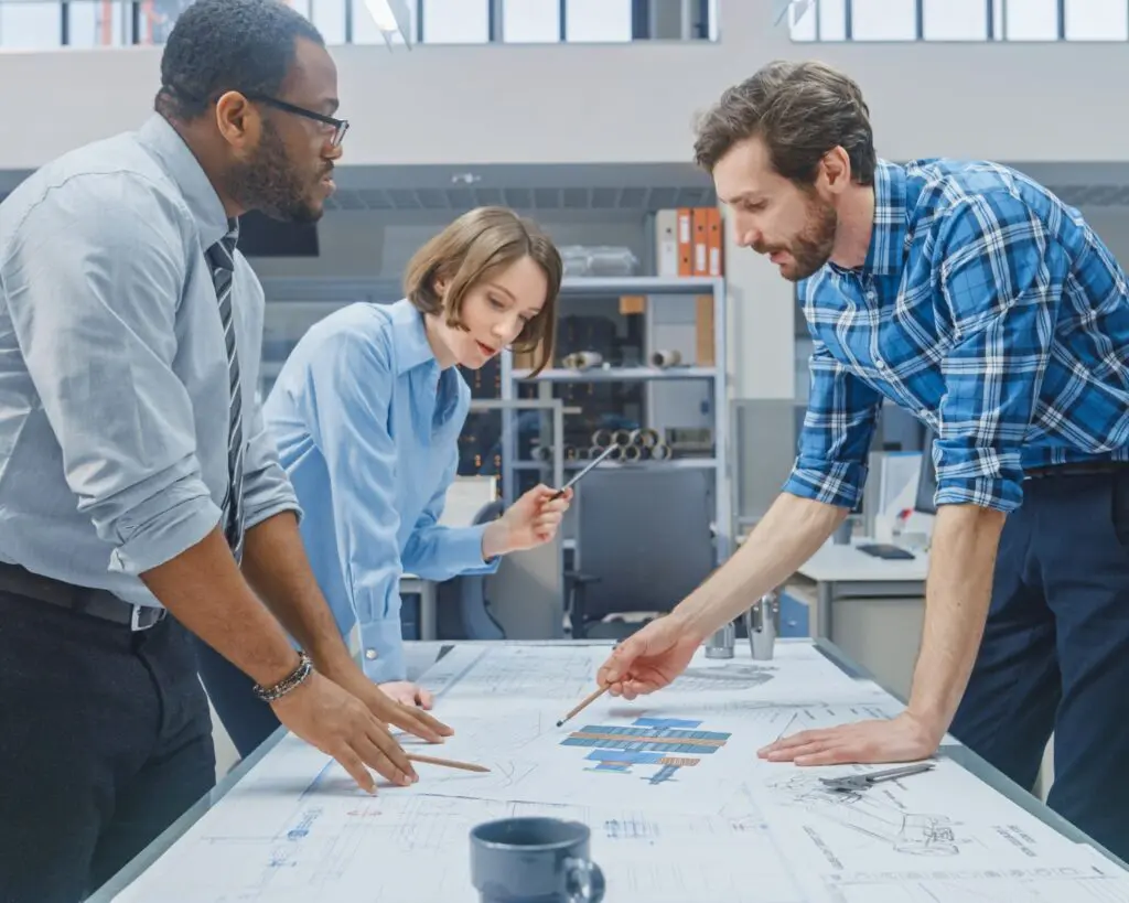 industrial engineering team discussing the scalability of a prototype design