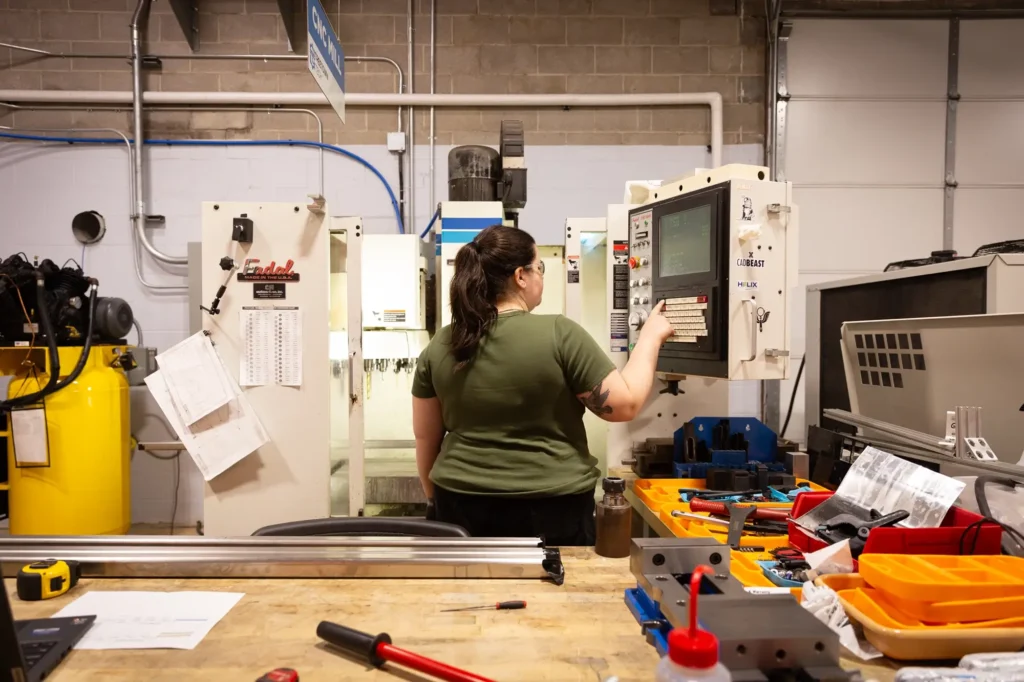 Woman working with machine in factory