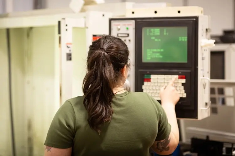 Woman working with machine in factory