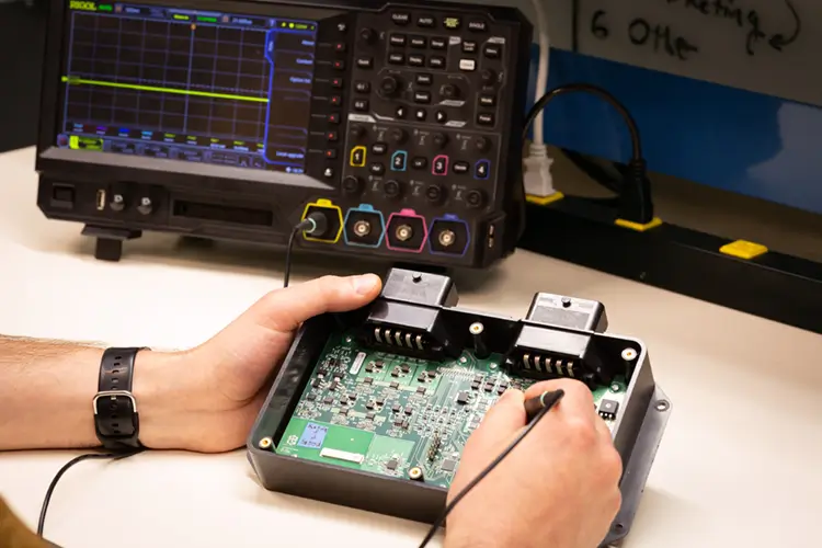 Treetown Tech employee working on a circuit board