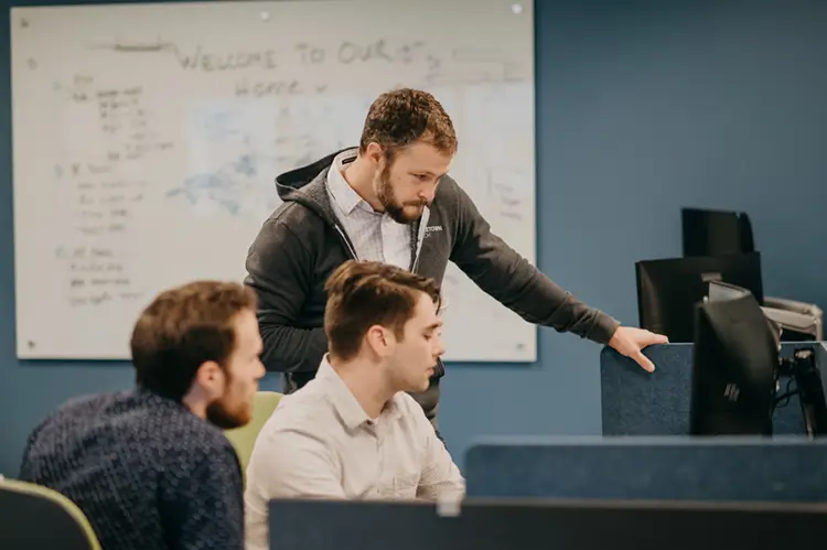 Treetown Tech employees looking at computer screen