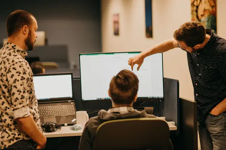 Treetown Tech employees looking at computer screen