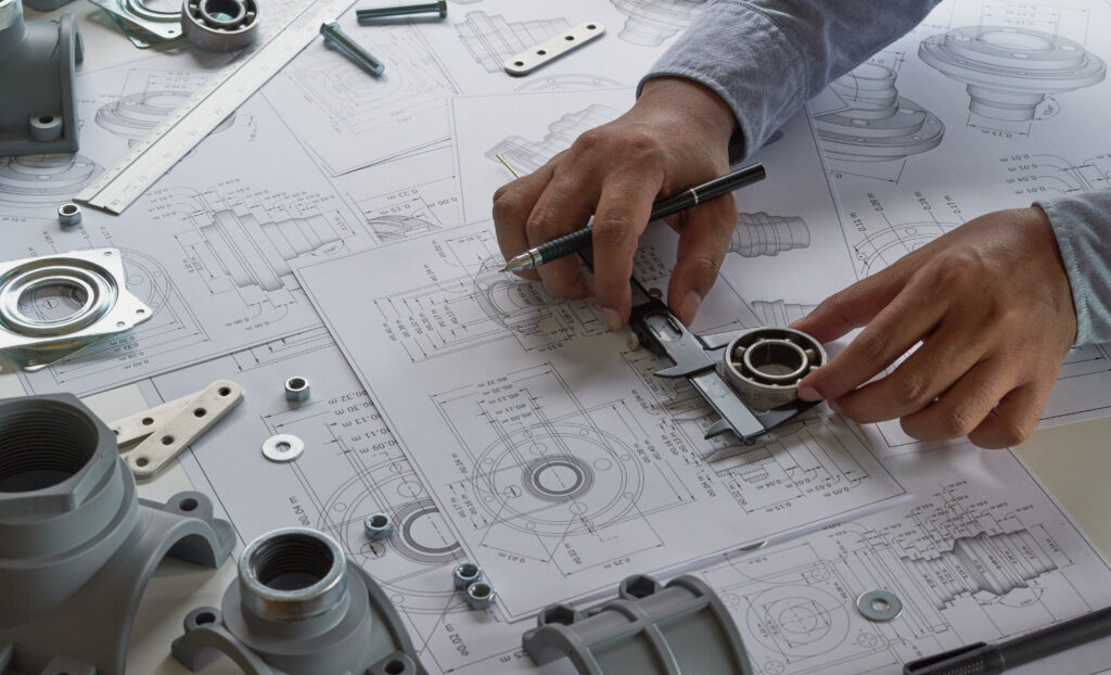 Engineer assembling an electronic circuit board with precision tools in a laboratory